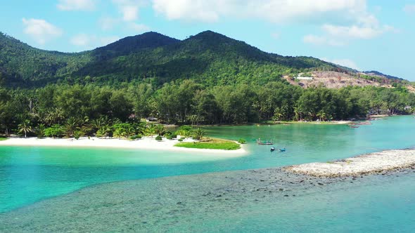 Vibrant colors of the tropical island coast. Malibu beach with turquoise water, mountains and jungle