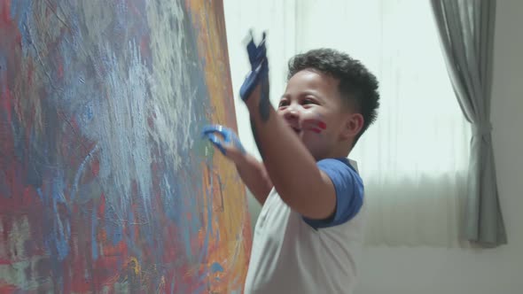 Little boy  Using Fingers She Creates Colorful