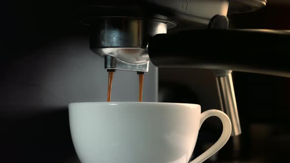 Pouring Coffee Stream From Machine in Cup