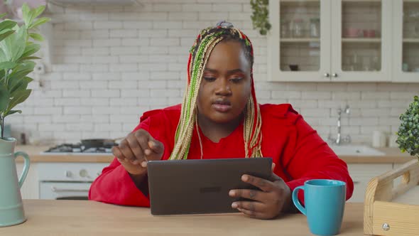 Serious African Woman Networking with Tablet Pc