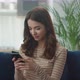 Happy Young Woman Shopping Having Fun Playing Games and Chatting on Smartphone - VideoHive Item for Sale