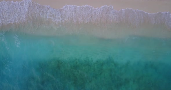 Daytime aerial travel shot of a sandy white paradise beach and aqua blue ocean background in best qu