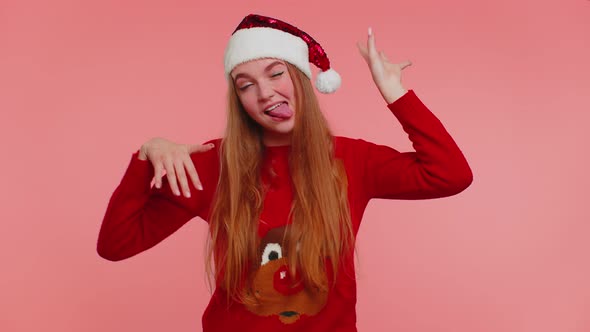 Crazy Girl in Christmas Santa Sweater Hat Demonstrating Tongue Out Fooling Around Making Silly Faces