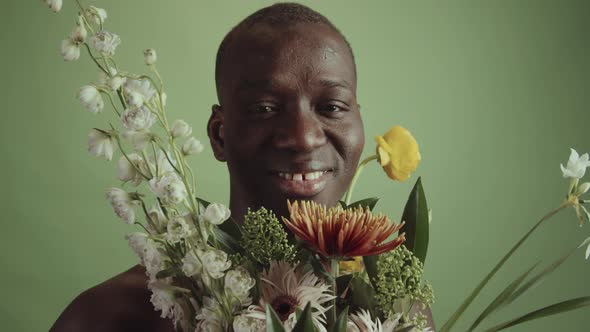 Happy Young Black Man With Flowers