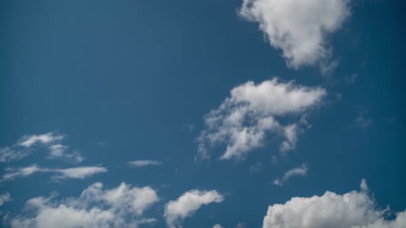 Beautiful timelapse of moving clouds at a blue skyed sunny day, shifting it's formation.