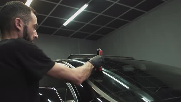 Professional Car Ceramics Worker Applies a Layer of Ceramics Protective Rain