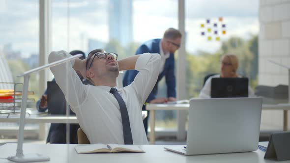 Happy Young Businessman Work in Modern Office Relaxing in Chair