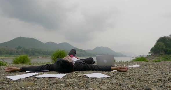 Business Suit With Laptop Among The Scattered Papers