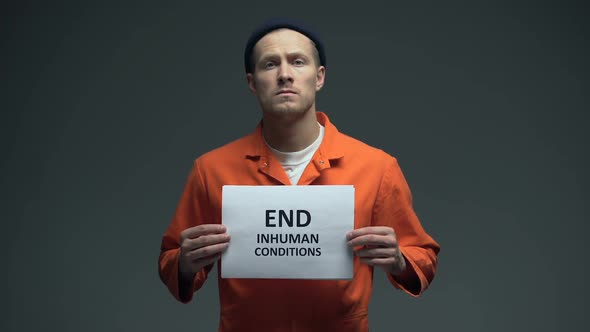 Prisoner Holding End Inhuman Conditions Sign in Cell, Human Rights Protection