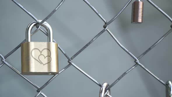 Endless fence with padlocks. Love. Interlocked hearts. Side view. Loopable. 4kHD