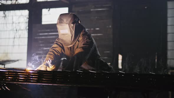 Worker with Protective Mask Welding Metal