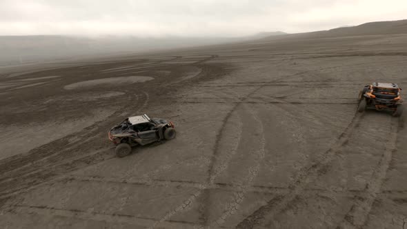 Large Buggy Automobiles Drift on Dried Salt Lake Territory