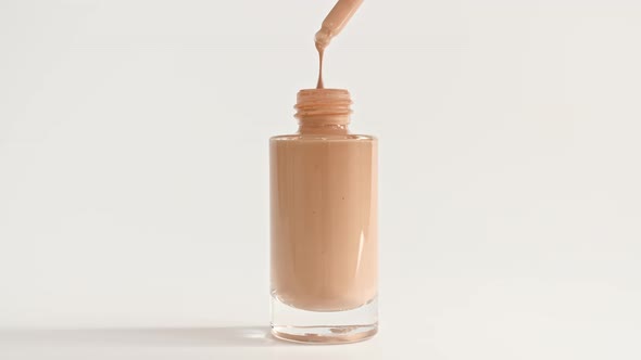 Foundation for Face Concealer Cosmetic Liquid Foundation Drips From a Pipette Into a Bottle