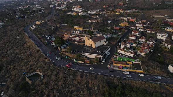 Aerial top-down circling over village with areas covered ash after Cumbre Vieja volcano eruption. La