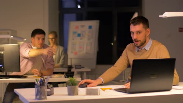 Office Worker with Laptop Asks Colleague for Help