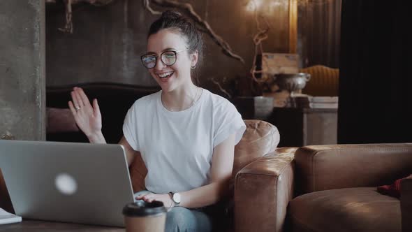 Happy Smiling Woman Having Conference Via Laptop Computer Sitting in Loft Space