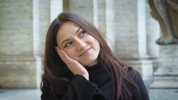 Pretty Young Woman Make the Gesture of The Dreamy Look in The Street