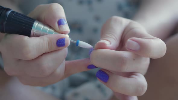 Manicurist Removes Purple Nail Polish on Her Hands