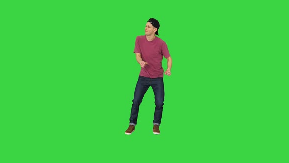 Caucasian Man Rapper Does Some Stylish Light Dancing on a Green Screen, Chroma Key.