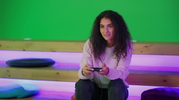 Young Woman is Playing Computer Game Pressing Joystick