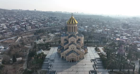 Aerial view of Holy Trinity Cathedral Sameba in Tbilisi Georgia. Sunrise drone footage.