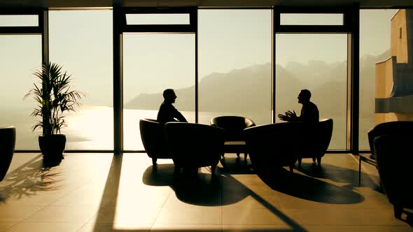 Two Business People Meeting Inside Modern Lobby 