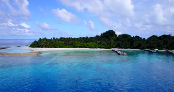 Beautiful above travel shot of a sandy white paradise beach and blue sea background in colourful 4K