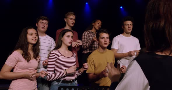 Teenagers rehearsing in a theatre