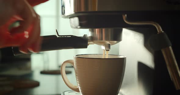 Pouring Coffee Stream From Machine in Cup