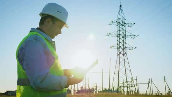 Architect Worker Checking Construction Project On Electric Tower