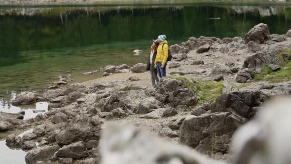 Hikers at Fusine lake, Italy