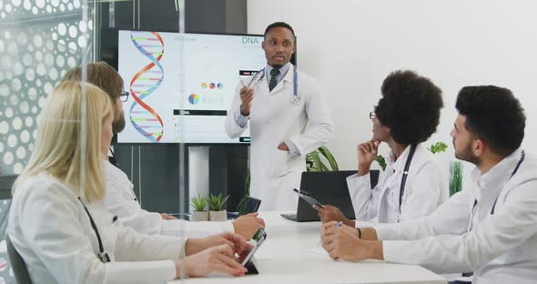 Medical Person Standing Near Interactive Screen and Presenting Report about Internal Human Organs