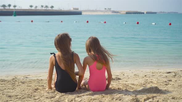 Little Happy Funny Girls Have a Lot of Fun at Tropical Beach Playing Together.