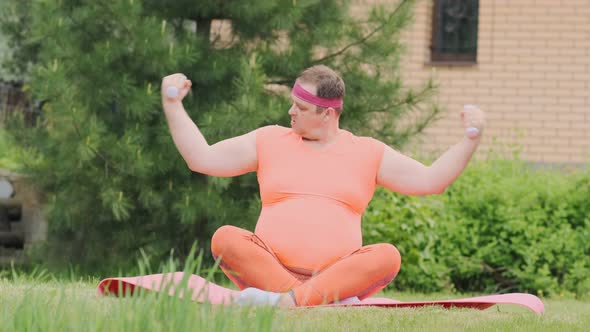 man engaged in bodybuilding outdoors