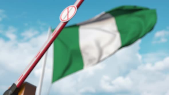 Closing Barrier with Stop Immigration Sign at the Nigerian Flag