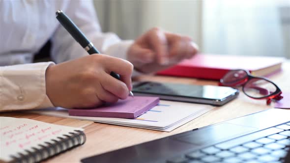 Woman Writes Data To Paper