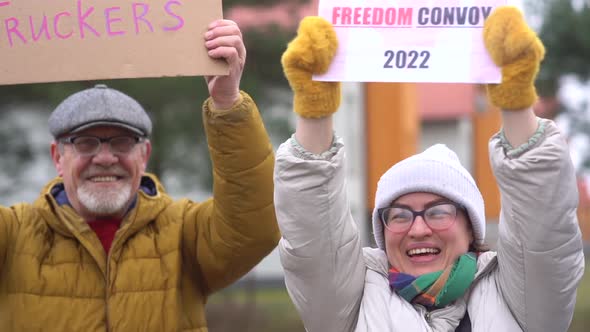 Outdoor Portrait of Smiling People with Inscriptions in Support of the Antivaccination Movement in