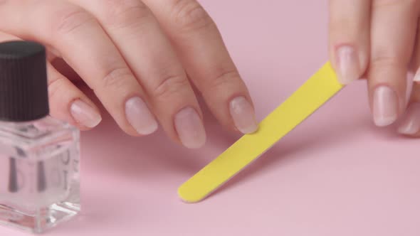 Woman Hand on Pink Makes Manicure for Herself