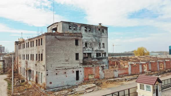 Abandoned building. Aerial view of an old factory ruin and broken windows.