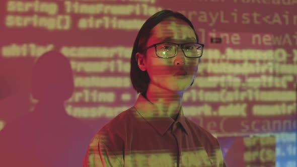 Portrait of Asian Programmer with Programming Codes on Face