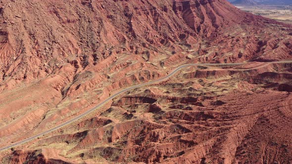 Highway Passes Through Picturesque Canyon With Red Sandstone Cliffs Aerial View