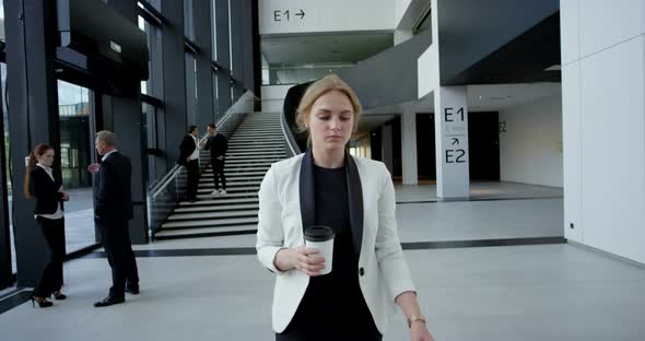 Business Woman Walking with Coffee