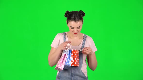 Girl Takes Out Small Box From the Packages and Is Very Happy on Green Screen