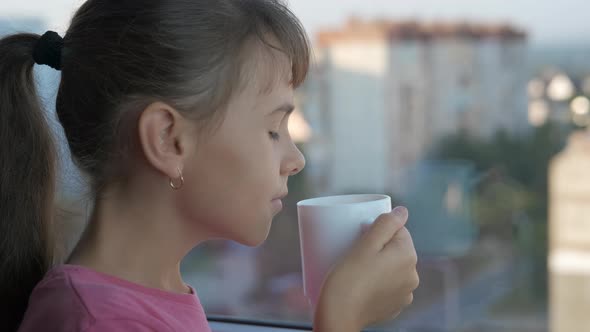 Child drink tea in the morning. 