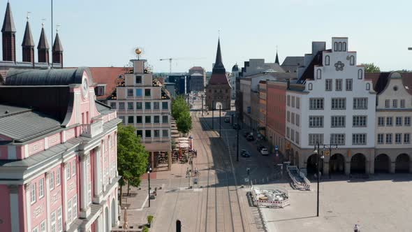 Forwards Fly Above Street with Tram Tracks Leading Through Historic City Centre