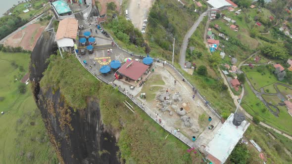 People on Top of the Scenic Rock of Guatape, Tourist site of Colombia - aerial drone shot