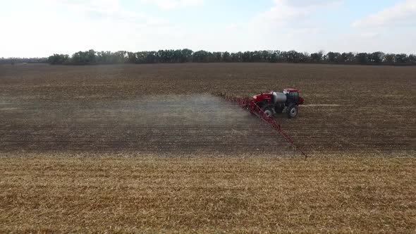 Red Tractor Plowing the Fields Corn in Spring, Aerial Shot