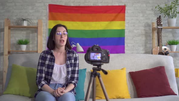 Young Woman Blogger in the Shirt on the Background of the Flag of the LGBT Records Video