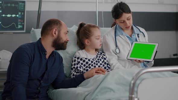 Pediatric Woman Doctor Holding Mock Up Green Screen Chroma Key Tablet with Isolated Display