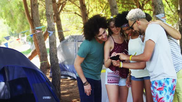 Friends looking at mobile phone in park 4k